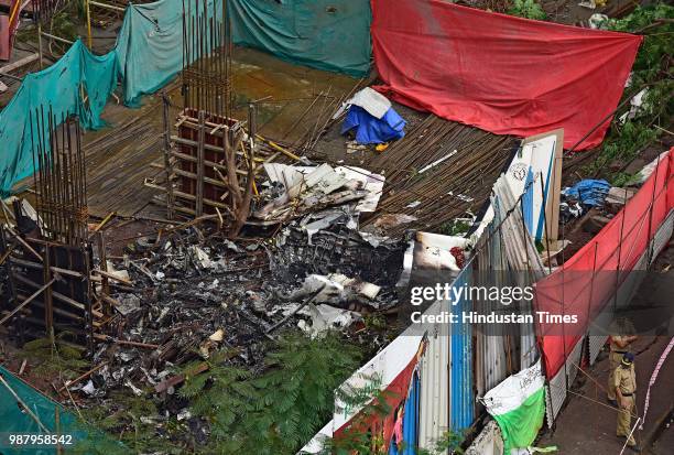 The debris of the chartered plane crash site Beechcraft King Air C90 turboprop at Jeev Daya Lane, near a telephone exchange at Ghatkopar area, on...