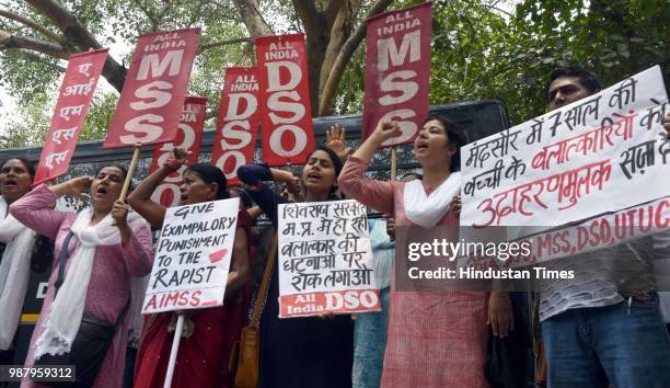 Member of AIMSS, AIDSO, AIDYO hold placards and shout slogans during a protest against the brutal rape of a seven-year-old girl in Mandsaur, Madhya...