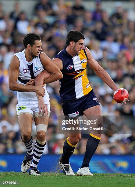 Michael Johnson of the Dockers tackles Dean Cox of the Eagles during the round six AFL match between the West Coast Eagles and the Fremantle Dockers...