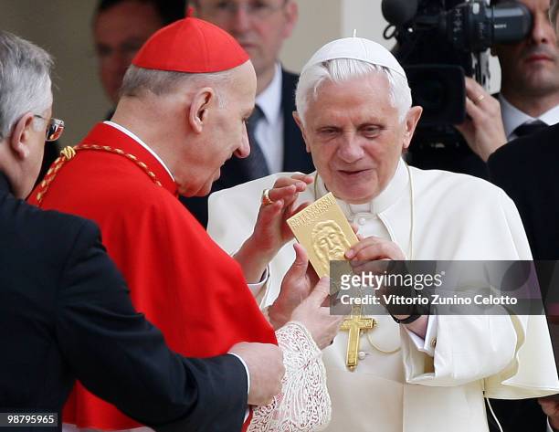 Archbishop of Turin Severino Poletto gives a plate with the effigy of the Holy Shroud to Pope Benedict XVI during a Holy Mass in Piazza San Carlo on...