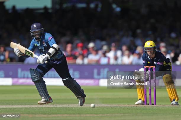 Daniel Bell-Drummond of Kent hits out as Hampshire wicket keeper Lewis McManus looks on during the Royal London One-Day Cup Final match between Kent...