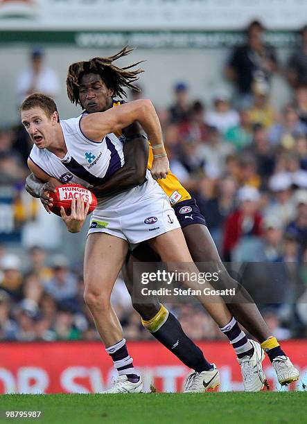 Michael Barlow of the Dockers is tackled by Nic Naitanui of the Eagles during the round six AFL match between the West Coast Eagles and the Fremantle...