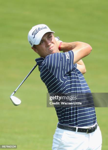 Justin Thomas of the USA plays his second shot into the first green during the third round of the HNA Open de France at Le Golf National on June 30,...