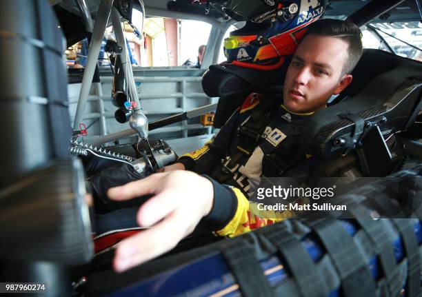 Alex Bowman, driver of the Axalta Chevrolet, sits in his car during practice for the Monster Energy NASCAR Cup Series Overton's 400 at Chicagoland...