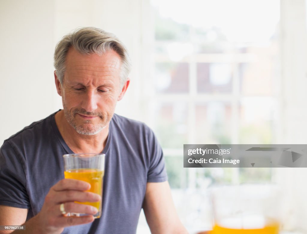 Mature man drinking juice