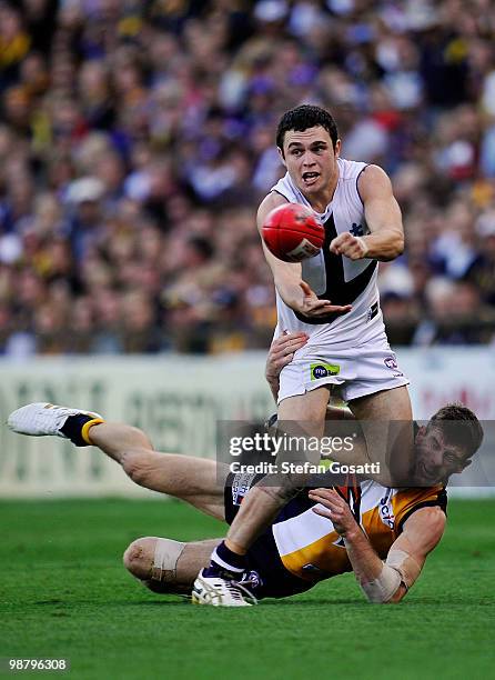 Hayden Ballantyne of the Dockers handballs as he collides with Beau Waters of the Eagles during the round six AFL match between the West Coast Eagles...