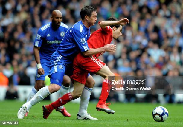 Yossi Benayoun of Liverpool is challenged by Frank Lampard of Chelsea during the Barclays Premier League match between Liverpool and Chelsea at...