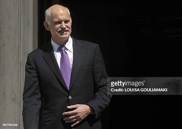 Greek prime minister George Papandreou stands outside his office in Athens on April 29, 2010. The EU and IMF have told the Greek government to slash...