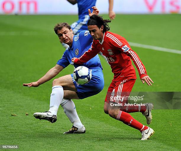 Alberto Aquilani of Liverpool competes with Branislav Ivanovic of Chelsea during the Barclays Premier League match between Liverpool and Chelsea at...