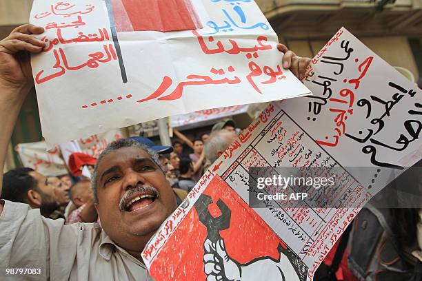 An Egyptian man shouts slogans while holding a list of daily household expenses during a protest demanding a higher minimum wage outside the...