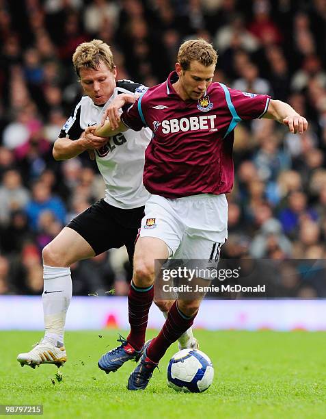 Jonathan Spector of West Ham United battles with of Fulham during the Barclays Premier League match between Fulham and West Ham United at Craven...