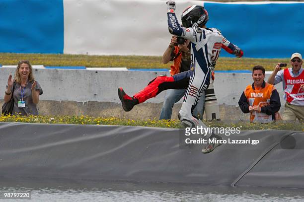 Jorge Lorenzo of Spain and Fiat Yamaha Team celebrates the victory and swimming on the lake at the end of the MotoGP race at Circuito de Jerez on May...