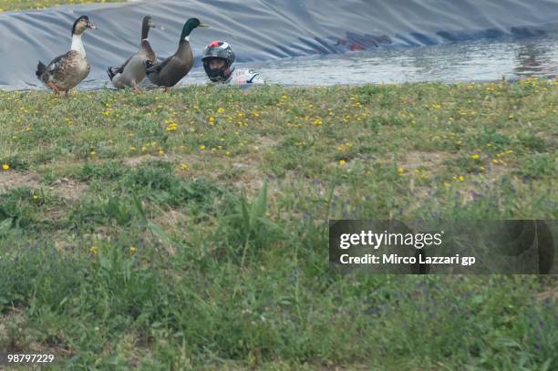 Jorge Lorenzo of Spain and Fiat Yamaha Team celebrates the victory and swimming on the lake with ducks at the end of the MotoGP race at Circuito de...