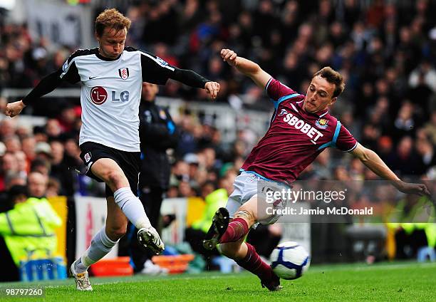 Bjorn Helge Riise of Fulham is tackled by Mark Noble of West Ham United during the Barclays Premier League match between Fulham and West Ham United...