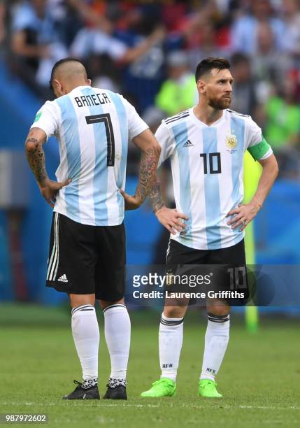 Ever Banega and Lionel Messi of Argentina look dejected following the 2018 FIFA World Cup Russia Round of 16 match between France and Argentina at...