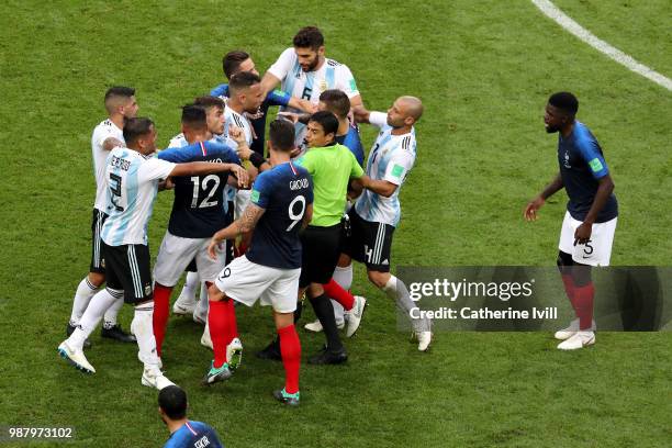 Referee Alireza Faghani tries to divide Argentina and France players during the 2018 FIFA World Cup Russia Round of 16 match between France and...