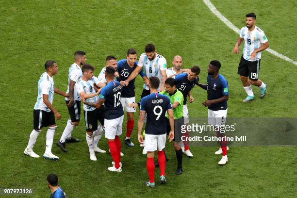 Referee Alireza Faghani tries to divide Argentina and France players during the 2018 FIFA World Cup Russia Round of 16 match between France and...