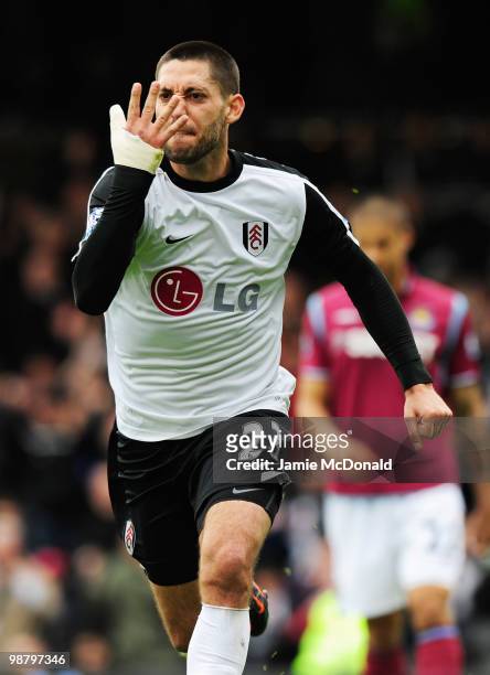 Clint Dempsey of Fulham celebrates as he scores their first goal during the Barclays Premier League match between Fulham and West Ham United at...
