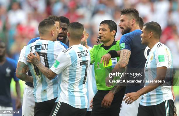 Referee Alireza Faghani looks to separate Argentina and France players as the clash during the 2018 FIFA World Cup Russia Round of 16 match between...