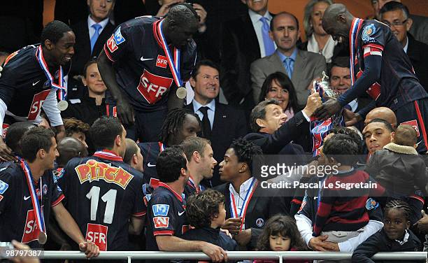 Paris Saint Germain football club midfielder and captain Claude Makelele receives the cup from French President Nicolas Sarkozy after winning the...