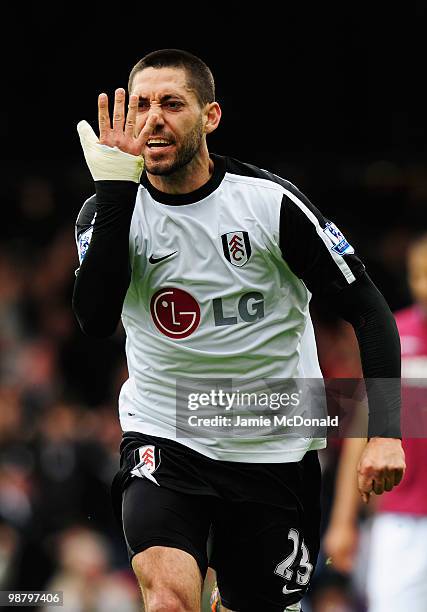 Clint Dempsey of Fulham celebrates as he scores their first goal during the Barclays Premier League match between Fulham and West Ham United at...