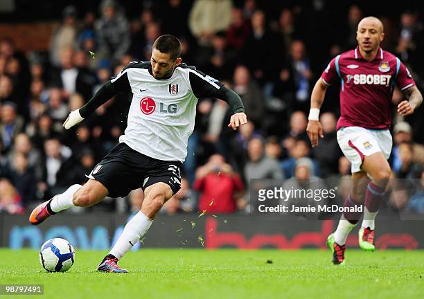 Clint Dempsey of Fulham scores their first goal during the Barclays Premier League match between Fulham and West Ham United at Craven Cottage on May...