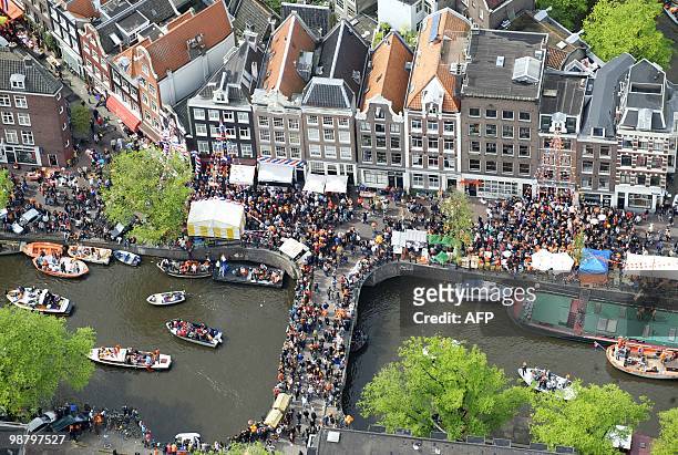 An aerial picture taken on April 30, 2010 shows people celebrating the Queen's Day 2010 gathered on bridges and boats in Amsterdam. AFP PHOTO/ ANP/...