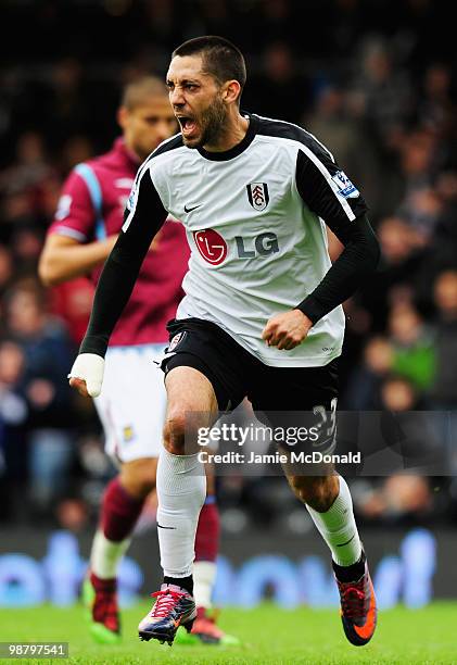 Clint Dempsey of Fulham celebrates as he scores their first goal during the Barclays Premier League match between Fulham and West Ham United at...