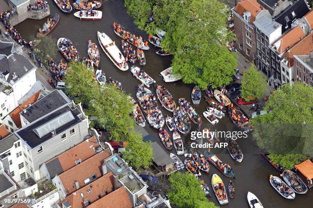 An aerial picture taken on April 30, 2010 shows people celebrating the Queen's Day 2010 gathered on boats in Amsterdam. AFP PHOTO/ ANP/ BRAM VAN DE...