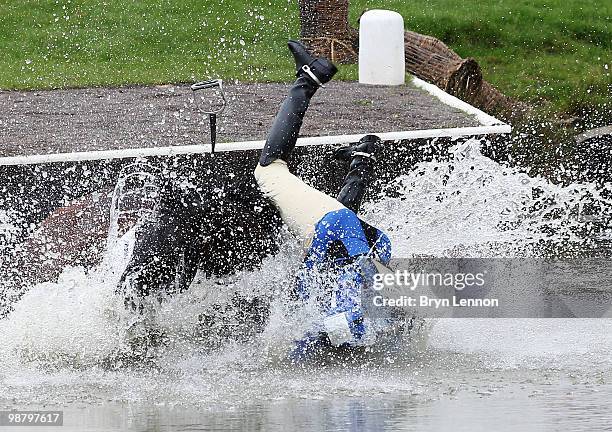 Kristina Cook of Great Britain falls from Miner's Frolic at the entrance to The Lake during the Cross Country Test on day three of the Badminton...