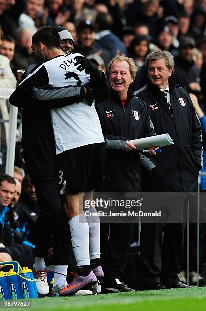 Fulham assistant Ray Lewington and manager Roy Hodgson look on as Clint Dempsey of Fulham celebrates with Dixon Etuhu as he scores their first goal...