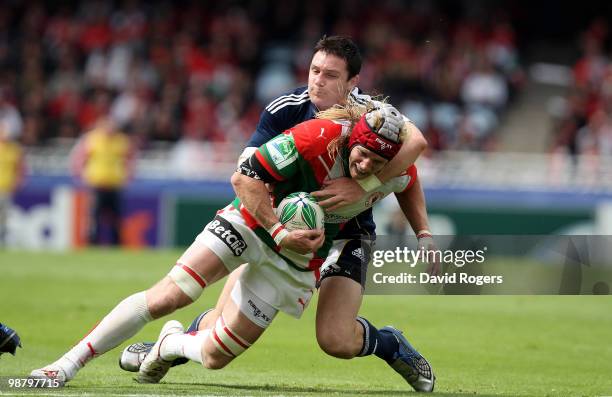 Magnus Lund of Biarritz is tackled by David Wallace during the Heineken Cup semi final match between Biarritz Olympique and Munster at Estadio Anoeta...