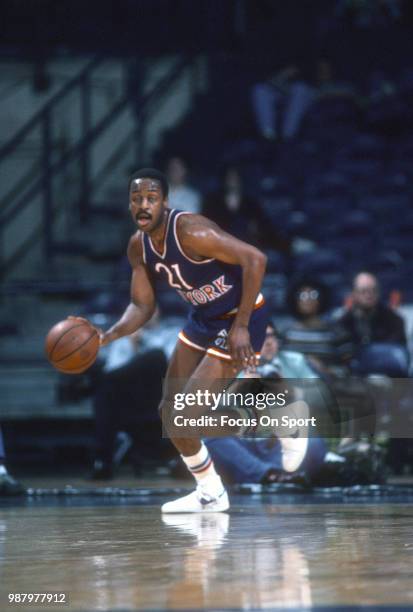 Campy Russell of the New York Knicks dribbles the ball up court against the Washington Bullets during an NBA basketball game circa 1982 at the...