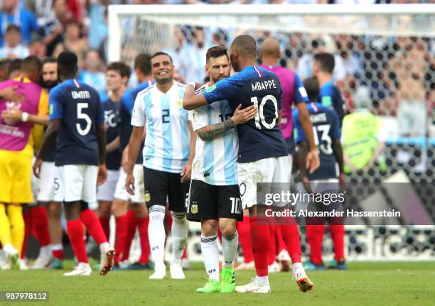 Kylian Mbappe of France consoles Lionel Messi of Argentina following France's victory in the 2018 FIFA World Cup Russia Round of 16 match between...