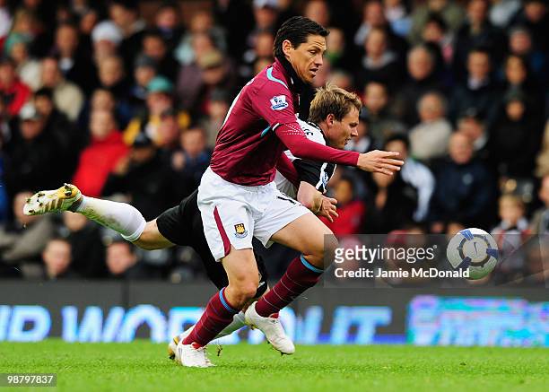 Guillermo Franco of West Ham United battles with Bjorn Helge Riise of Fulham during the Barclays Premier League match between Fulham and West Ham...