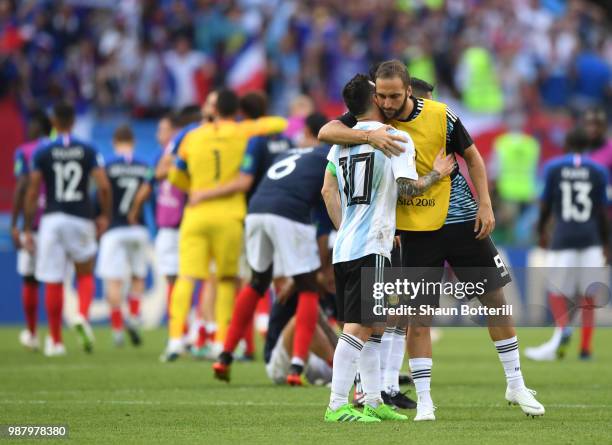 Lionel Messi of Argentina speaks with teammate Gonzalo Higuain of Argentina following their sides defeat in the 2018 FIFA World Cup Russia Round of...