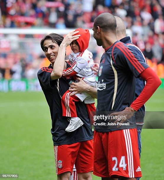 Yossi Benayoun of Liverpool walks round Anfeild with his child at the end of the Barclays Premier League match between Liverpool and Chelsea at...