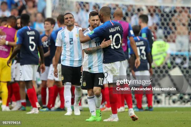 Kylian Mbappe of France consoles Lionel Messi of Argentina following France's victory in the 2018 FIFA World Cup Russia Round of 16 match between...