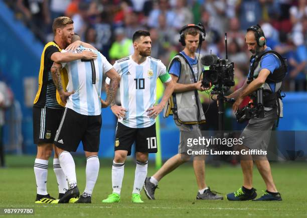 Cristian Ansaldi of Argentina consoles teammate Ever Banega of Argentina following their sides defeat in the 2018 FIFA World Cup Russia Round of 16...
