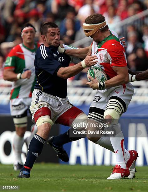 Imanol Harinordoquy of Biarritz, wearing a face protector, holds off Alan Quinlan during the Heineken Cup semi final match between Biarritz Olympique...