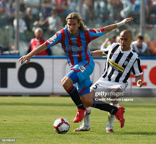 Maximiliano Maxi Lopez of Catania Calcio competes for the ball with Fabio Cannavaro of Juventus FC during the Serie A match between Catania and...