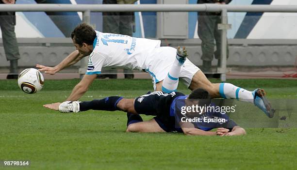 Dmitri Grachyov of FC Saturn Moskovskaya Oblast battles for the ball with Aleksandr Kerzhakov of FC Zenit St. Petersburgg during the Russian Football...