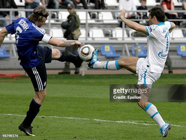 Aleksei Igonin of FC Saturn Moskovskaya Oblast battles for the ball with Aleksandr Kerzhakov of FC Zenit St. Petersburg during the Russian Football...