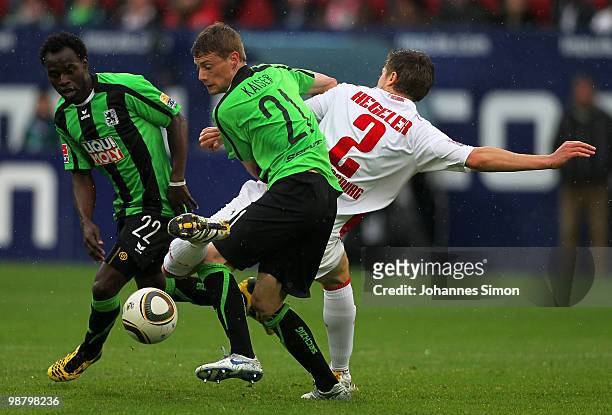 Jens Hegeler of Augsburg battles for the ball with Sandro Kaiser and Eke Uzoma of Muenchen during the Second Bundesliga match between FC Augsburg and...