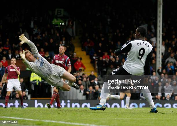 Fulham's Stefano Okaka scores his goal against West Ham United beating the goalkeeper West Ham United's Robert Green during a Premier League match at...