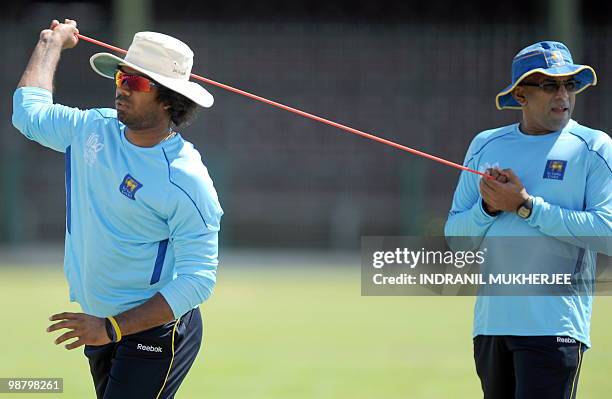 Sri Lankan cricketer Lsith Malinga exercise during a training session at the Georgetown Cricket Club ahead of their match of the ICC World Twenty20...