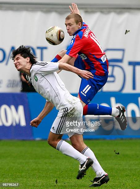 Pavel Mamaev of PFC CSKA Moscow battles for the ball with Sergey Kovalchuk of FC Tom Tomsk during the Russian Football League Championship match...