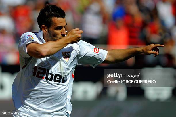 Sevilla's midfielder Alvaro Negredo celebrates after scoring against Atletico Madrid during a Spanish league football match at Ramon Sanchez Pizjuan...