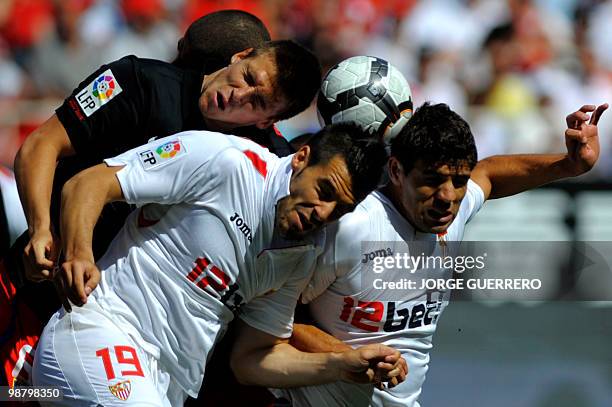 Sevilla's midfielder Â�lvaro Negredo and Argentinian defender Federico Fazio vie for the ball with Atletico Madrid's midfielder Ignacio Camacho...