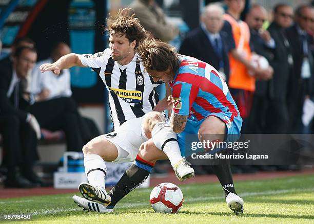 Pablo Alvarez of Catania Calcio competes for the ball with Diego Ribas da Cunha of Juventus FC during the Serie A match between Catania and Juventus...